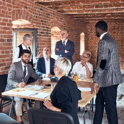 Group of business people brainstorming together in meeting room