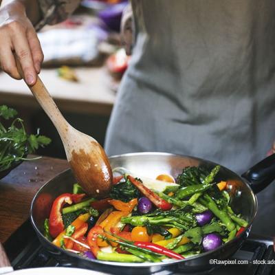 Person cooking vegetables