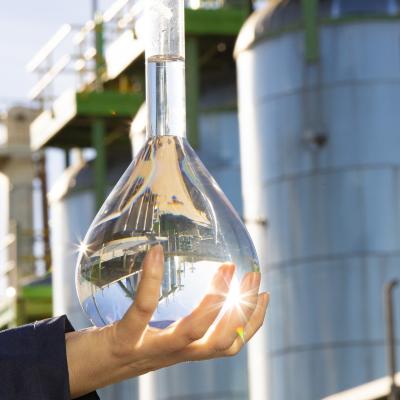 hand holding bioethanol in front of flagship