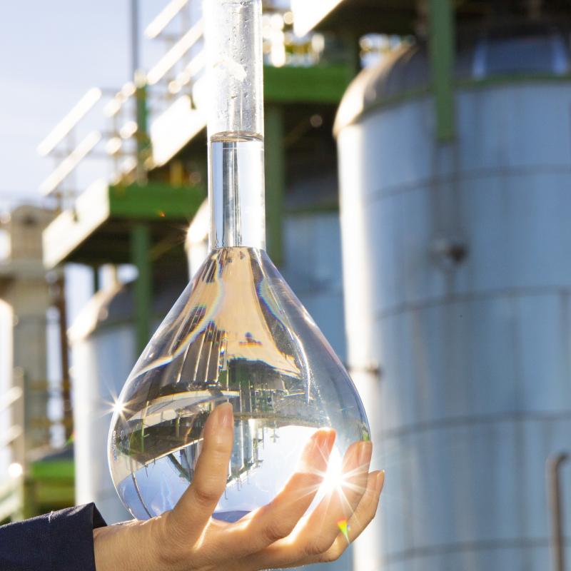 hand holding bioethanol in front of flagship